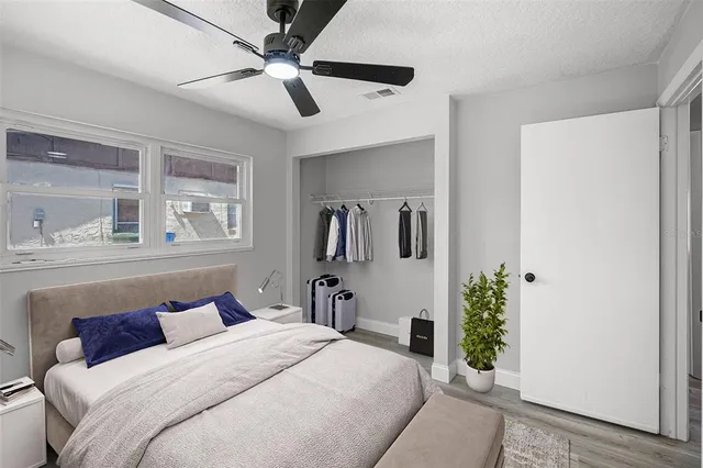 a bedroom with a bed and a chandelier