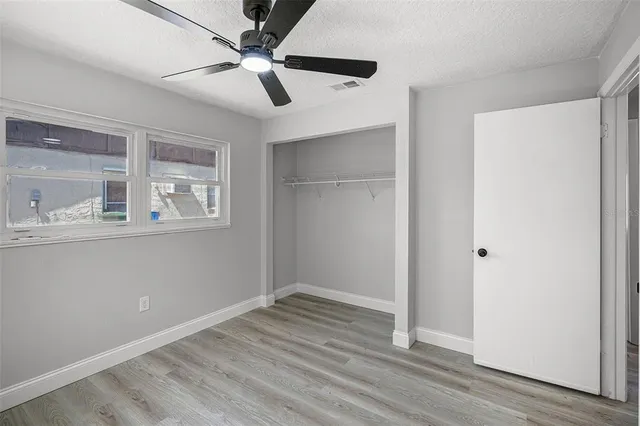a view of empty room with wooden floor