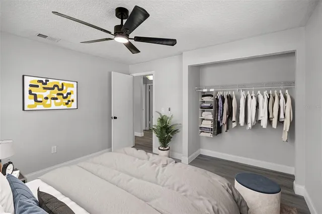 a bedroom with a bed and a chandelier