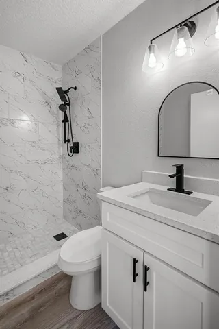 a bathroom with a sink toilet and shower