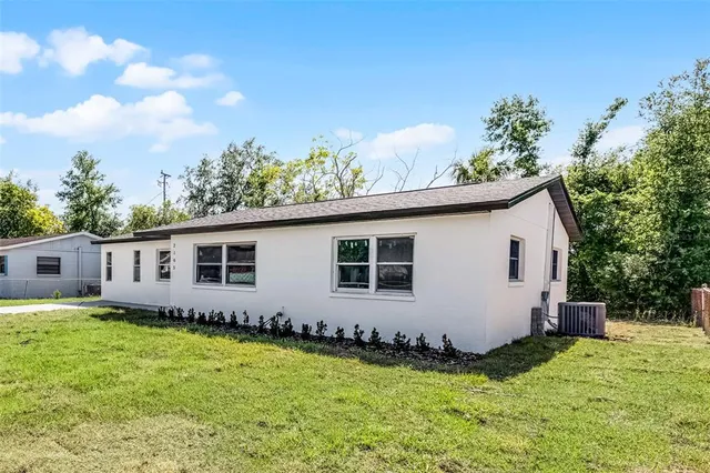 a backyard of a house with wooden fence and porch