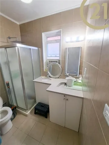 a bathroom with a sink a toilet a mirror and shower