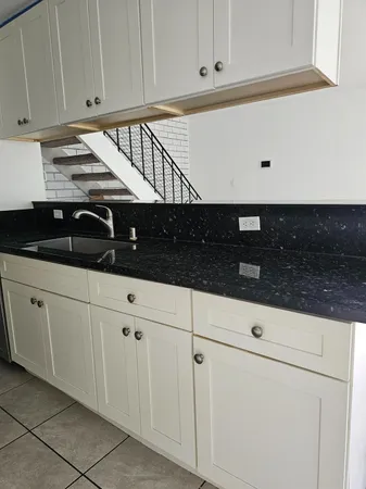 a kitchen with white cabinets