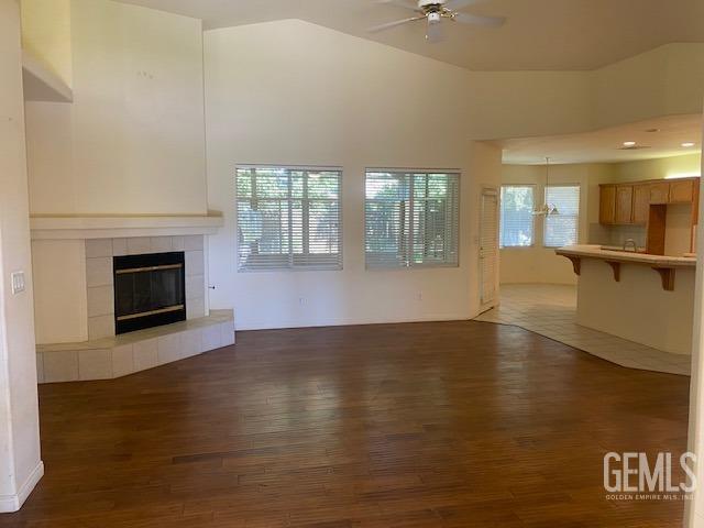 Undisclosed Address Bakersfield, CA 93312 - Photo 2 of 19 an empty room with wooden floor and fireplace