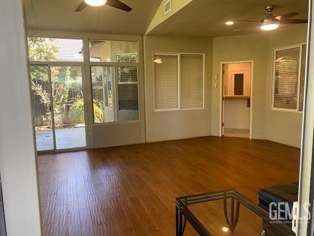 Undisclosed Address Bakersfield, CA 93312 - Photo 10 of 19 a view of an empty room with a window and wooden floor