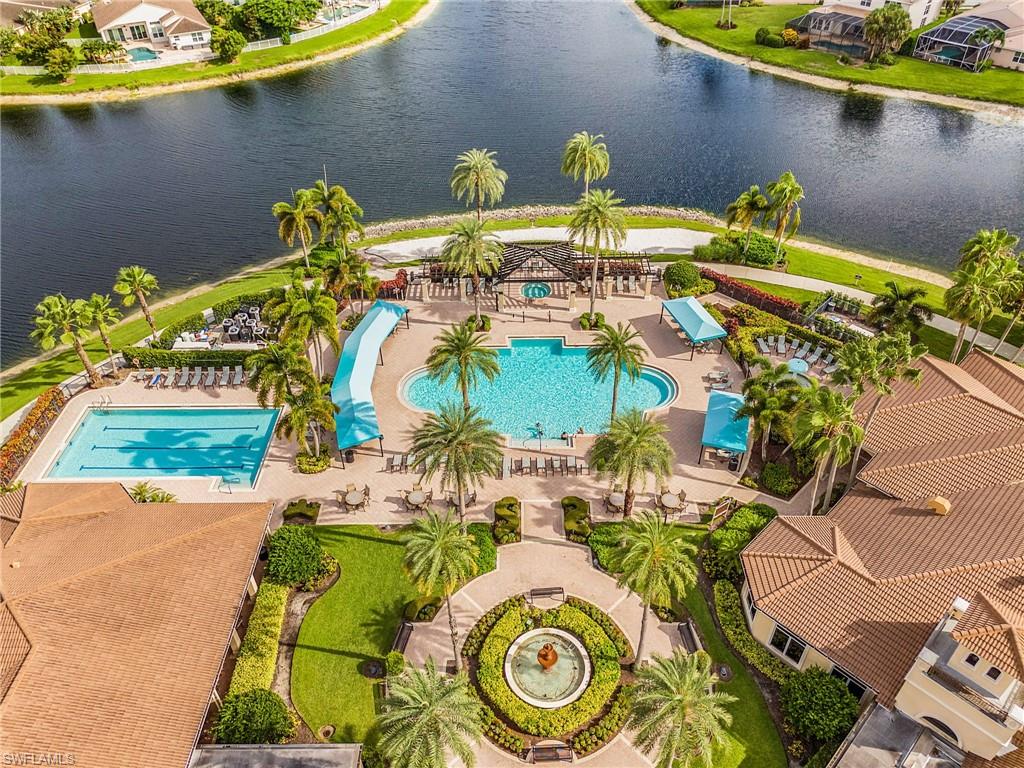 1415 Princess Sabal Point Naples, FL 34119 - Photo 32 of 42 Expansive aquatic facility featuring a resort-style pool with a waterslide, a lap pool, and a large central fountain