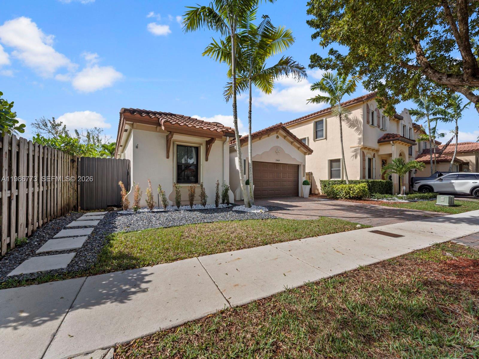a view of a house with backyard and tree s