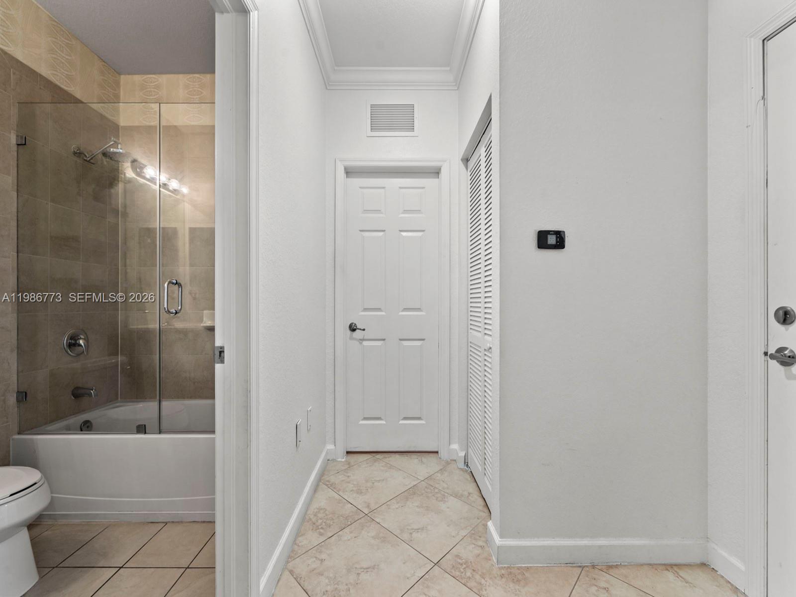 15404 Southwest 175th Street Miami, FL 33187 - Photo 21 of 38 a bathroom with a bathtub and a shower