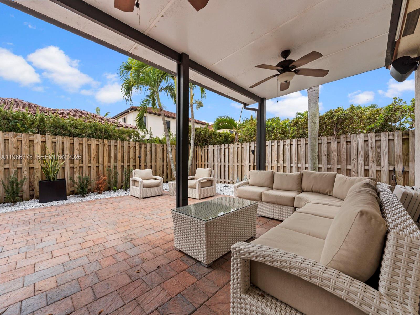 15404 Southwest 175th Street Miami, FL 33187 - Photo 26 of 38 a building outdoor space with patio couch and a potted plant