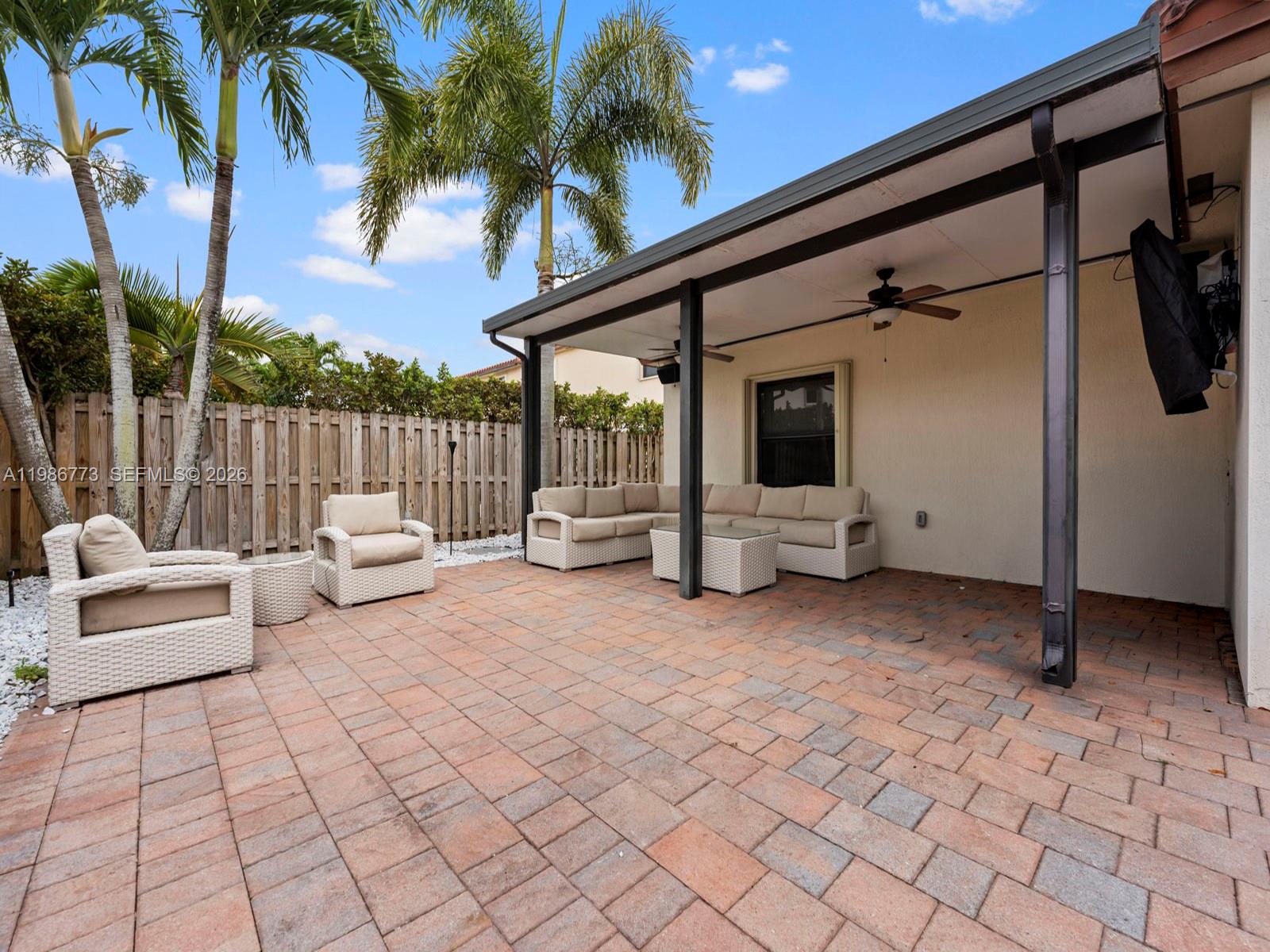 15404 Southwest 175th Street Miami, FL 33187 - Photo 29 of 38 a view of a patio with couches and a table and chairs