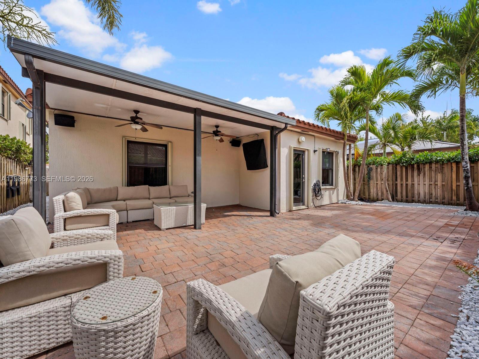 15404 Southwest 175th Street Miami, FL 33187 - Photo 30 of 38 a outdoor living space with furniture and a potted plant
