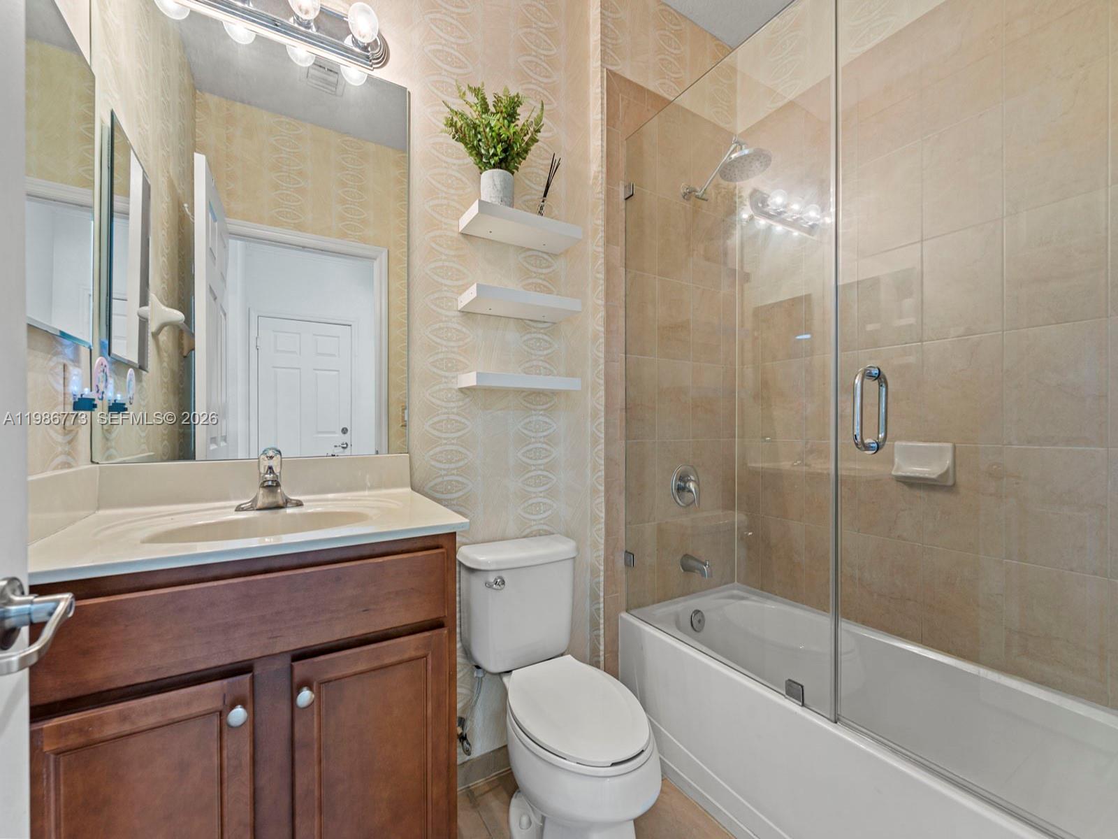 15404 Southwest 175th Street Miami, FL 33187 - Photo 5 of 38 a bathroom with a sink toilet and shower