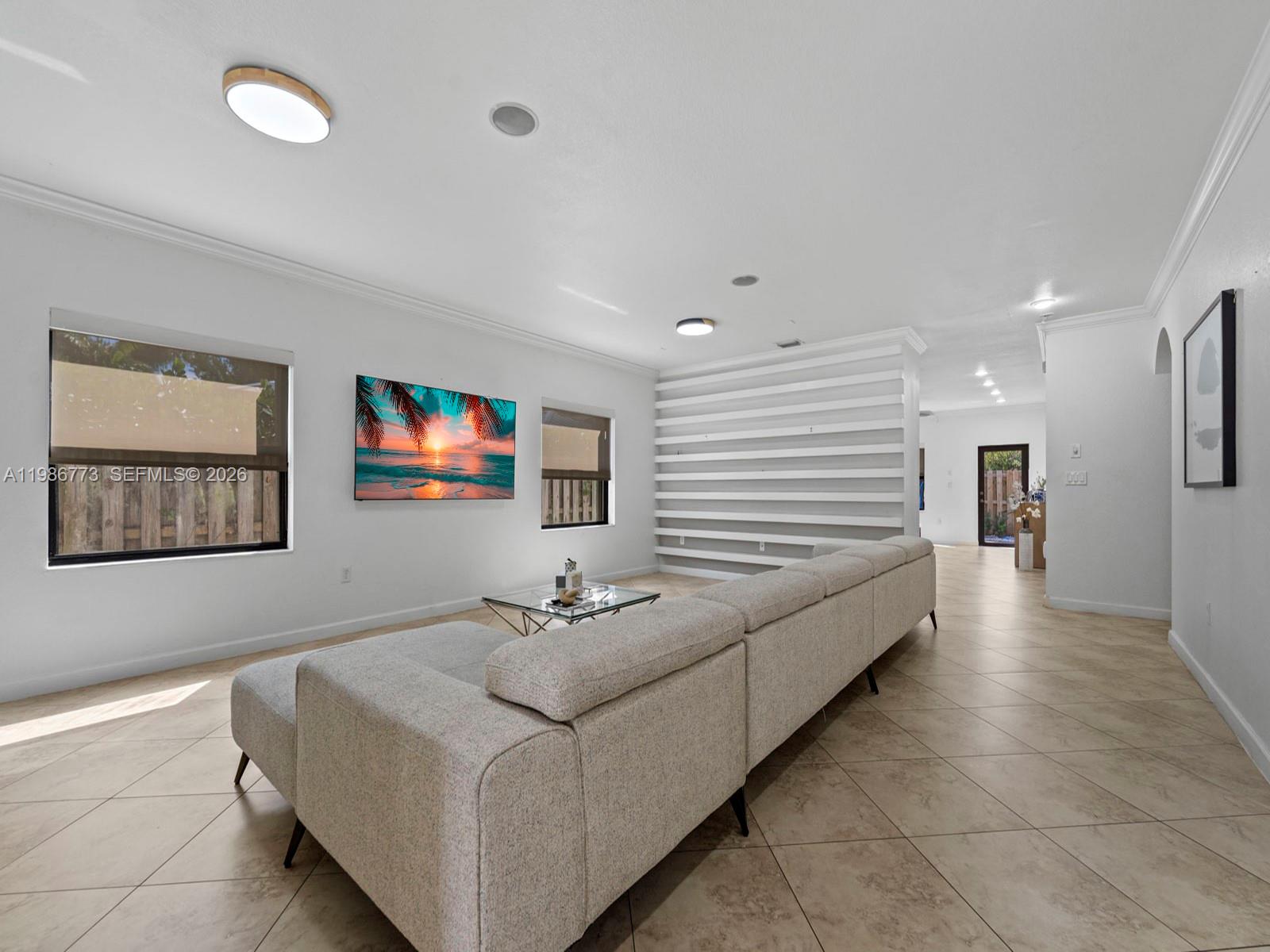 15404 Southwest 175th Street Miami, FL 33187 - Photo 6 of 38 a living room with furniture and a flat screen tv