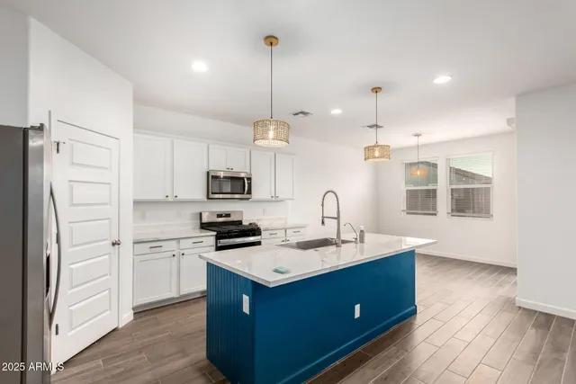 a kitchen with a sink stove and refrigerator