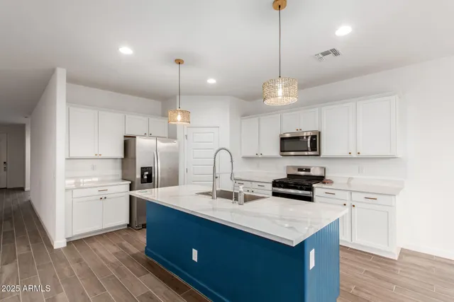 a kitchen with refrigerator cabinets and wooden floor