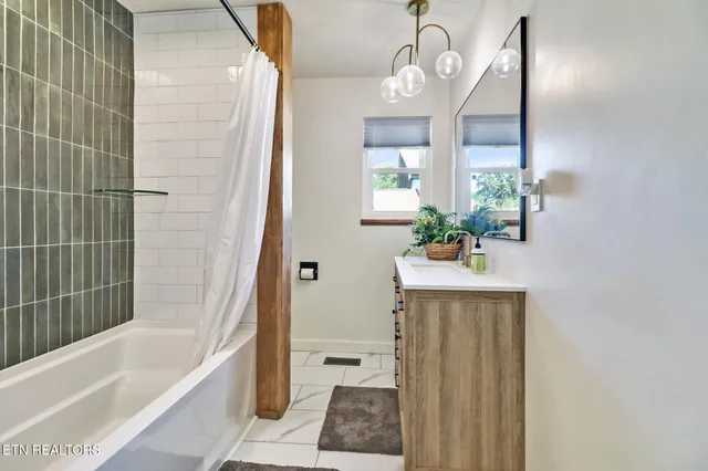 a bathroom with a bathtub a sink and a mirror