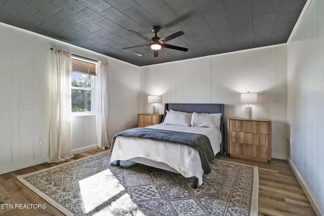 a bedroom with a large bed and a rug