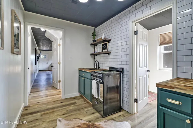 a kitchen with a sink and a stove top oven