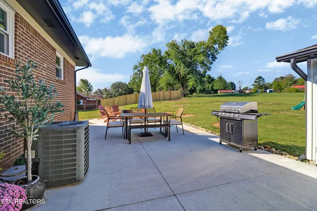 a view of a patio with chairs and a table