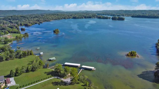 an aerial view of a house with a yard and lake view
