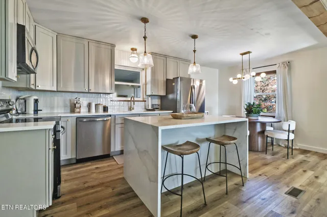 a kitchen with a sink cabinets and window