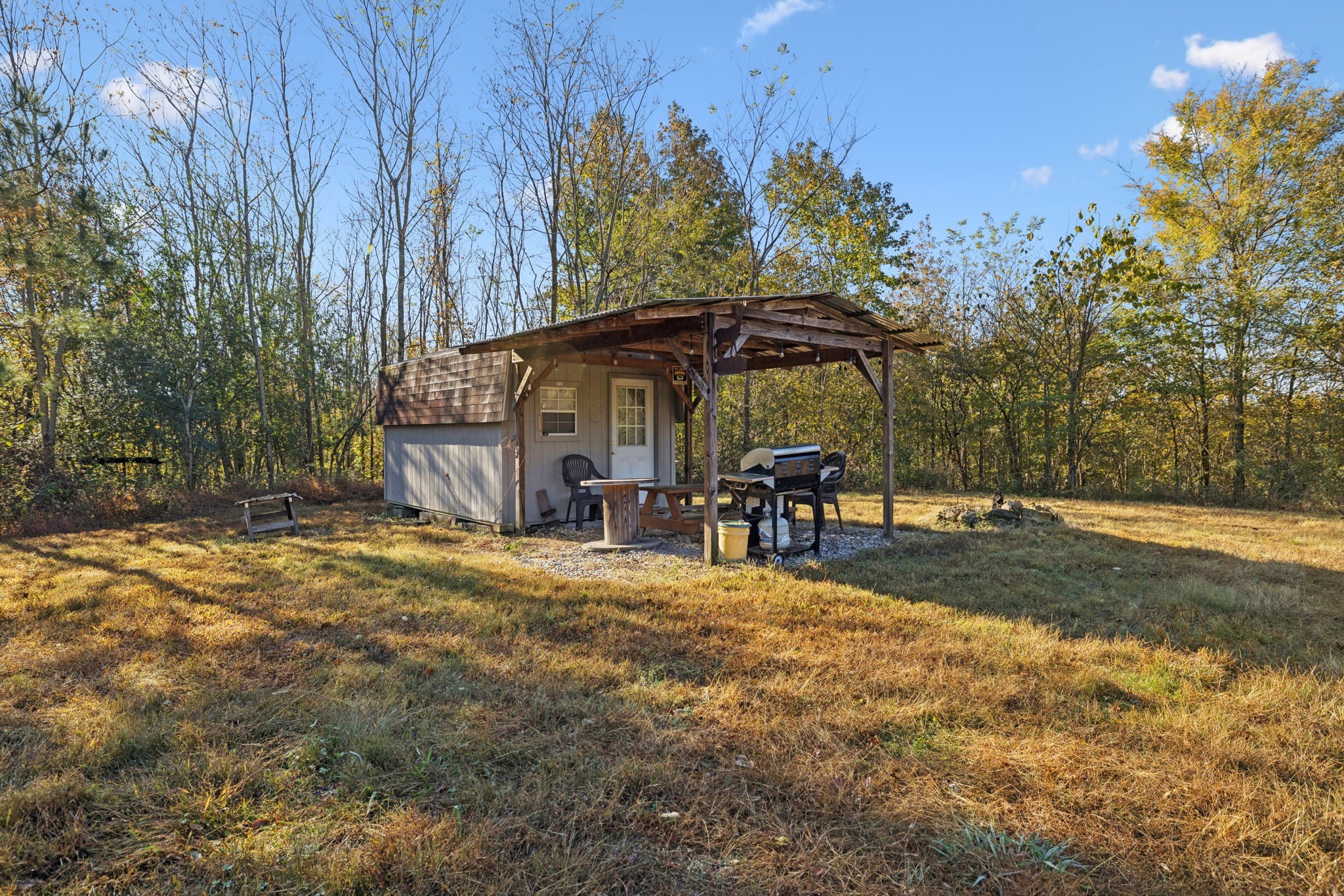 0 West Sheepneck Road Mount Pleasant, TN 38474 - Photo 17 of 43 a view of a patio with table and chairs under an umbrella