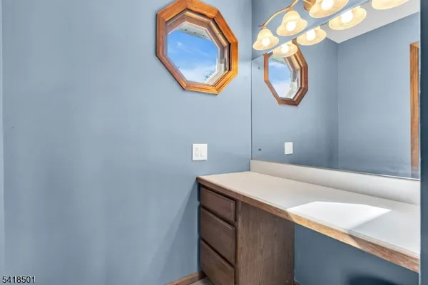 a bedroom with a bed and dresser with mirror