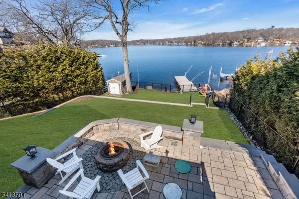 an aerial view of a house with outdoor space and lake view