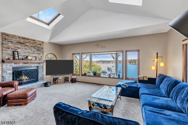 a living room with furniture flat screen tv and a fireplace