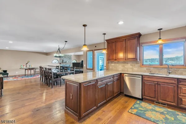a kitchen with stainless steel appliances granite countertop a stove sink and cabinets