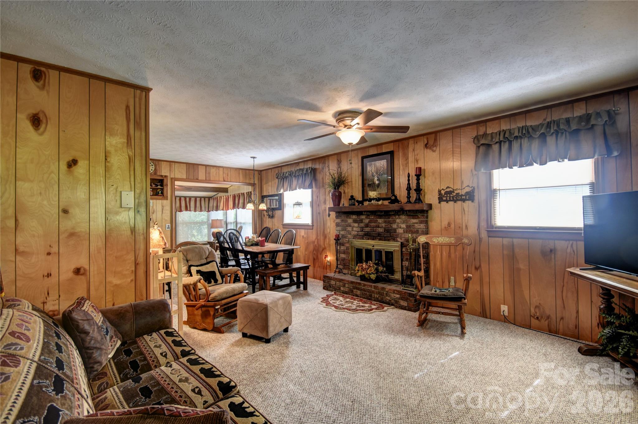 134 Raven Ridge Maggie Valley, NC 28751 - Photo 3 of 23 a living room with furniture a fireplace and a flat screen tv