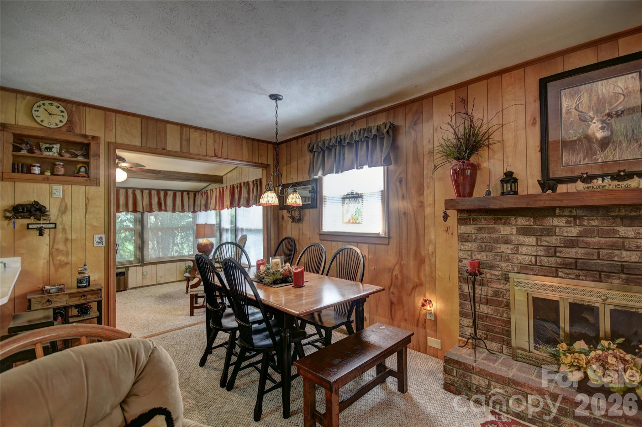 134 Raven Ridge Maggie Valley, NC 28751 - Photo 7 of 23 a dining room with furniture a fireplace and wooden floor