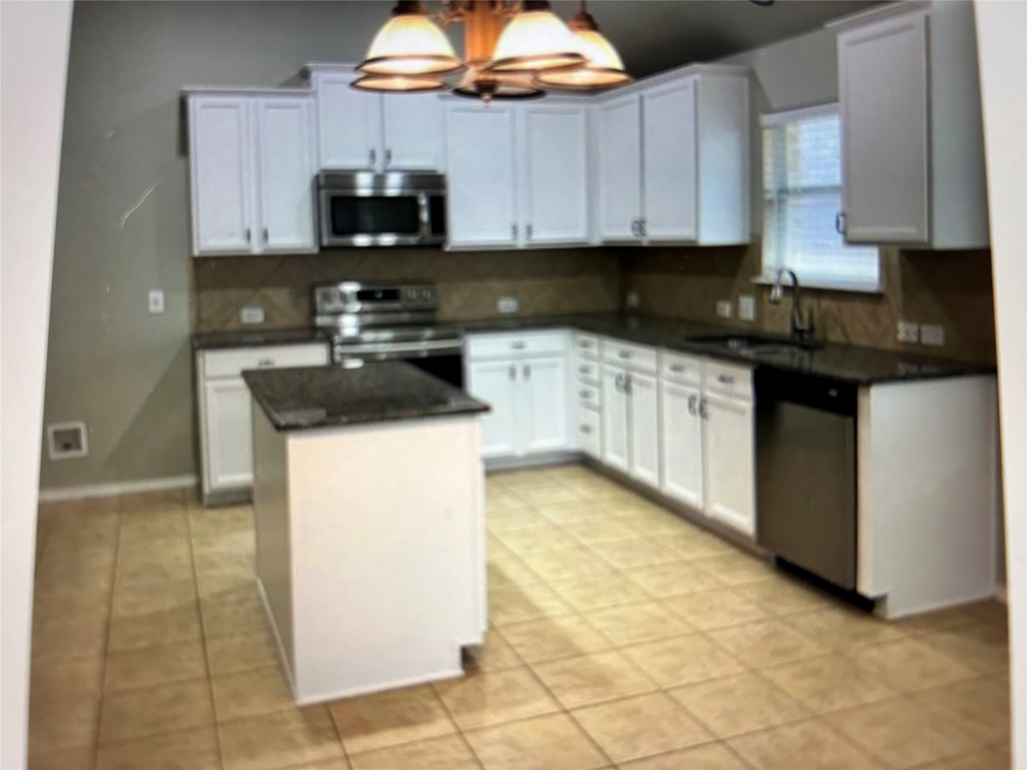 211 Animas Drive Georgetown, TX 78626 - Photo 10 of 25 a kitchen with granite countertop a sink a stove and cabinets