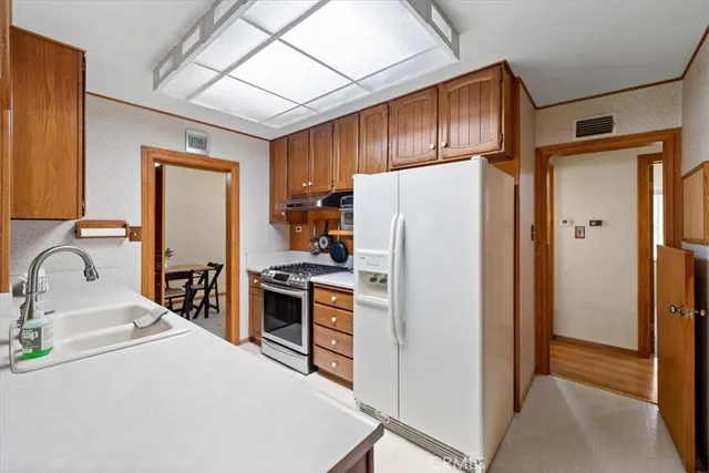 a kitchen with a stove a sink and a refrigerator
