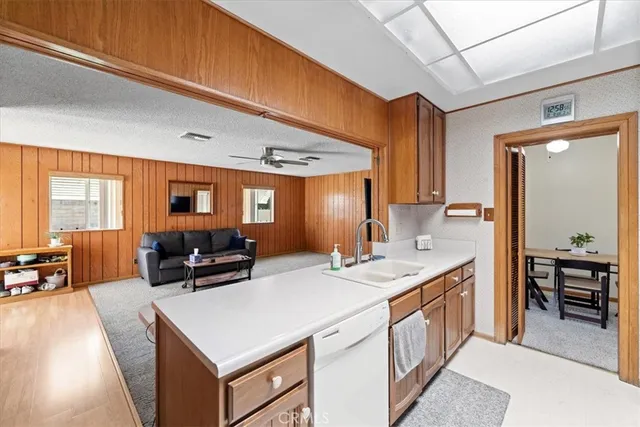 a kitchen with stainless steel appliances a refrigerator a sink a stove and cabinets