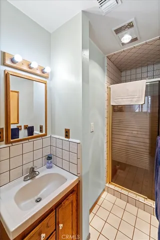 a bathroom with a sink a toilet and mirror