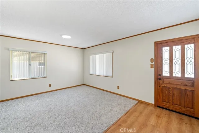 a workspace with wooden floor and a chandelier fan