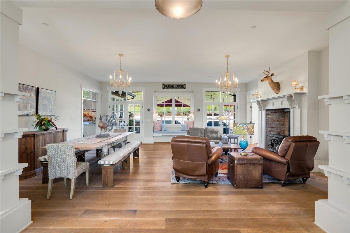 7670 Crews Road Gilroy, CA 95020 - Photo 32 of 83 a living room with furniture a fireplace and a chandelier