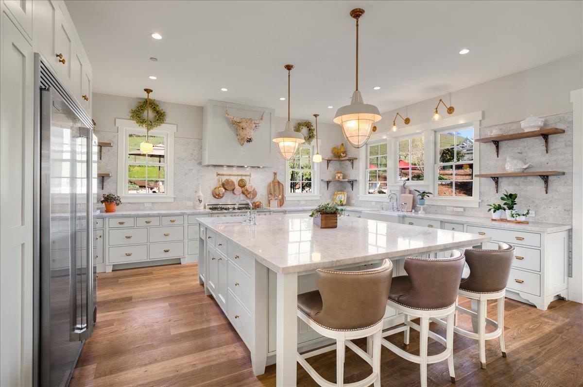 7670 Crews Road Gilroy, CA 95020 - Photo 41 of 83 a kitchen with stainless steel appliances kitchen island granite countertop a stove a sink and a chandelier