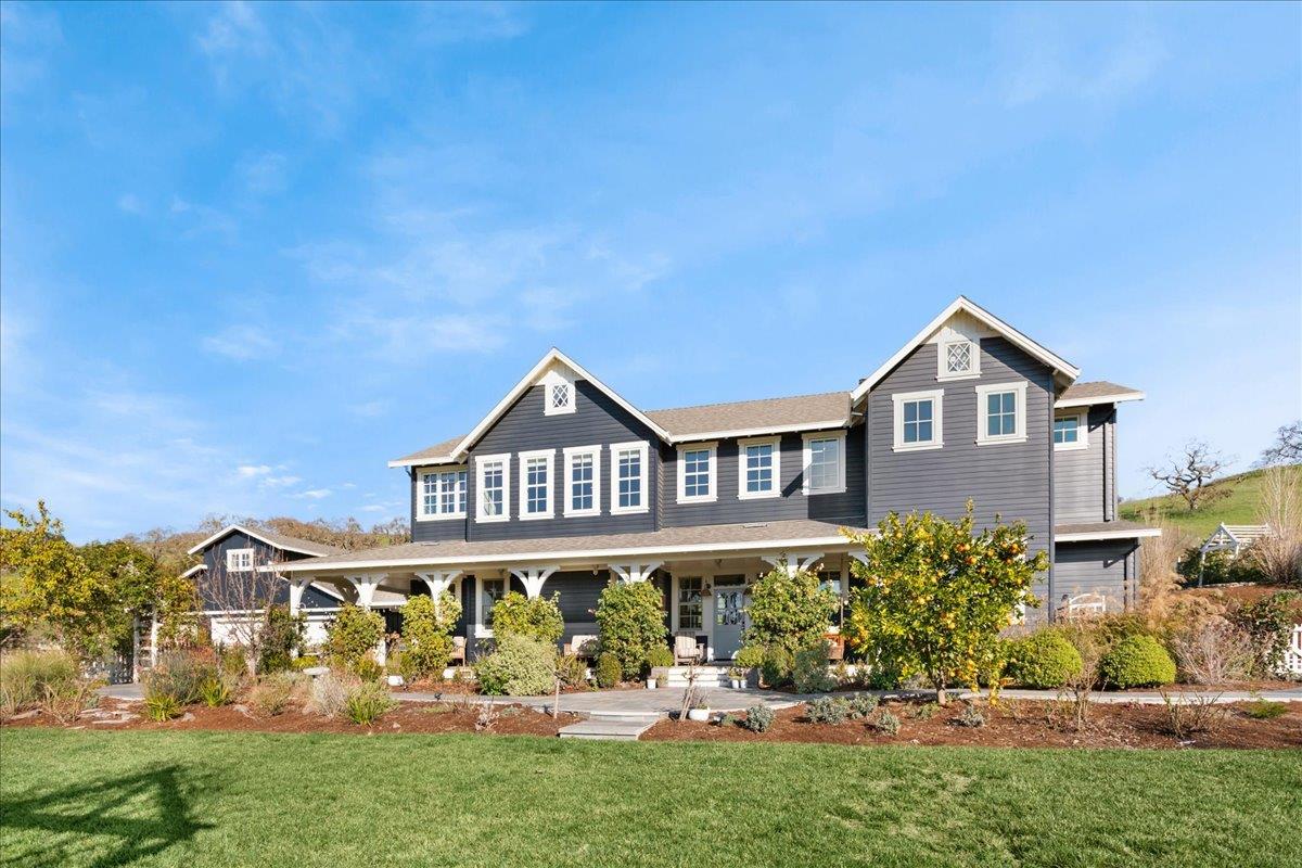 7670 Crews Road Gilroy, CA 95020 - Photo 7 of 83 a front view of a house with a yard and potted plants