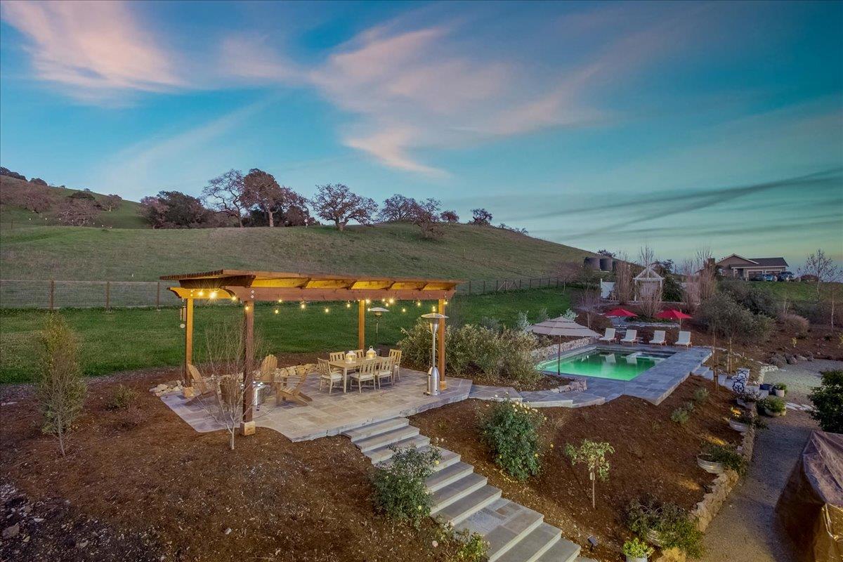 7670 Crews Road Gilroy, CA 95020 - Photo 72 of 83 a view of a patio with table and chairs potted plants with lake view