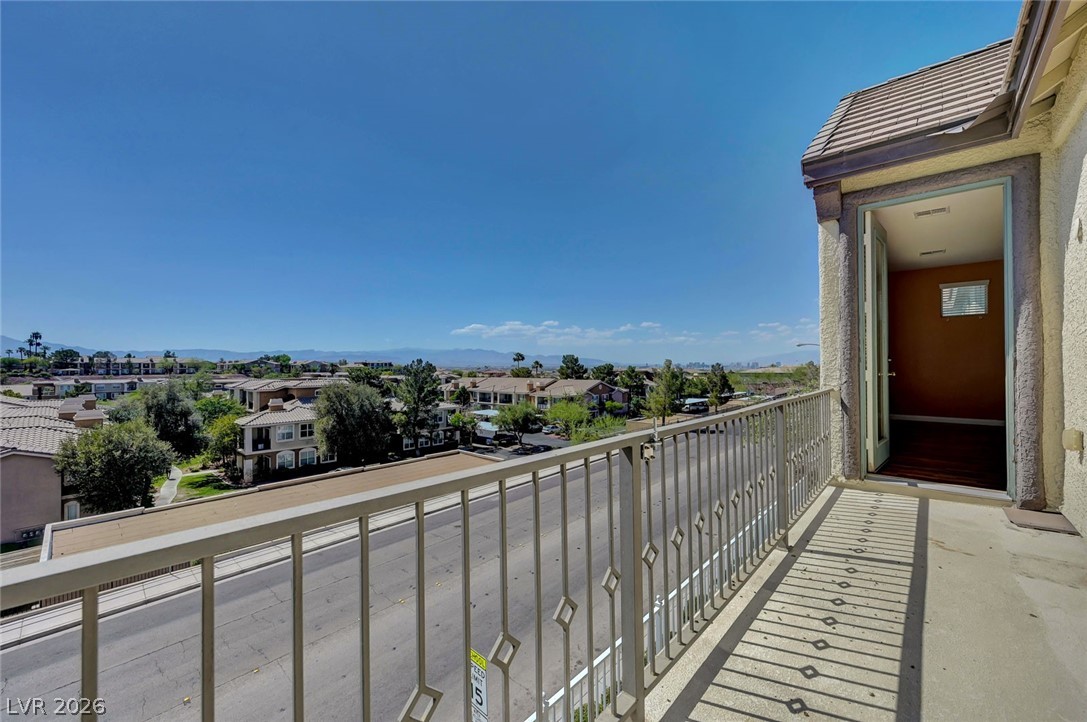 977 Sparkling Light Street Henderson, NV 89052 - Photo 45 of 75 Balcony from Primary Bedroom. This outdoor space offers expansive neighborhood views with distant mountains under a clear sky.