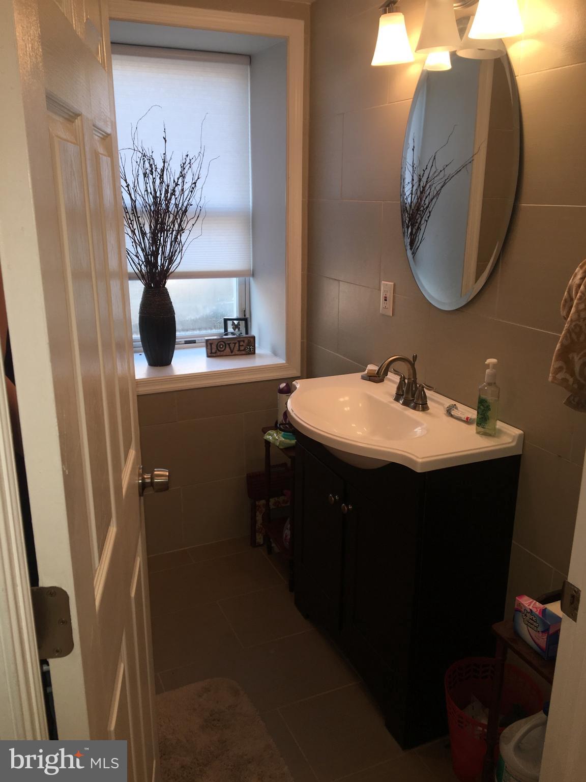 4203 Main Street, Unit 2 Philadelphia, PA 19127 - Photo 7 of 16 a bathroom with a sink and mirror