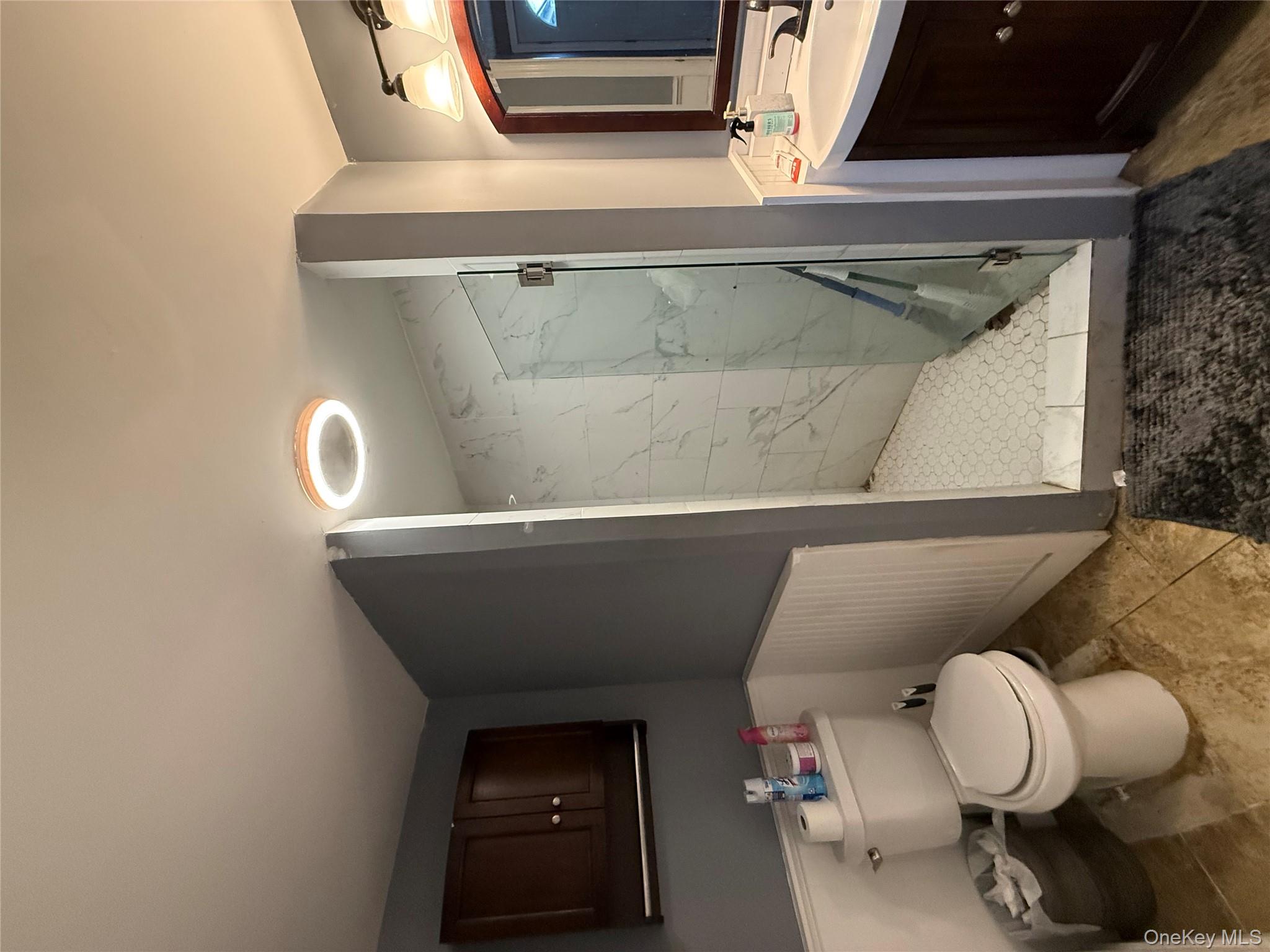 17 Hampton Road Shirley, NY 11967 - Photo 17 of 26 a bathroom with a toilet sink and shower