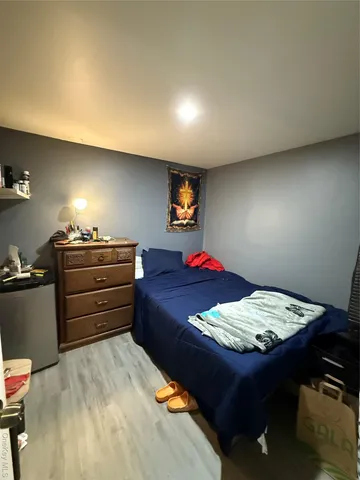 a bed sitting in a bedroom and dresser