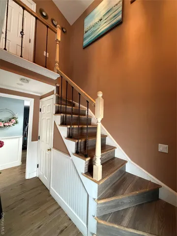 a view of entryway and hall with wooden floor