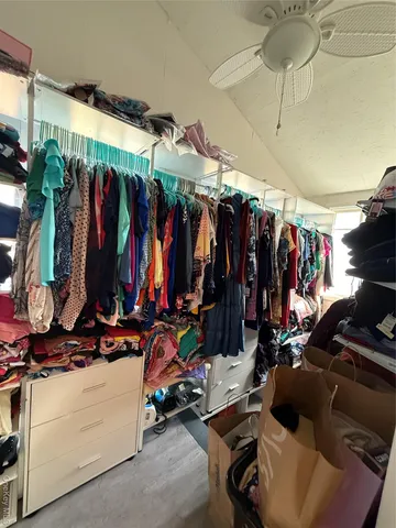 a view of walk in closet with clothes