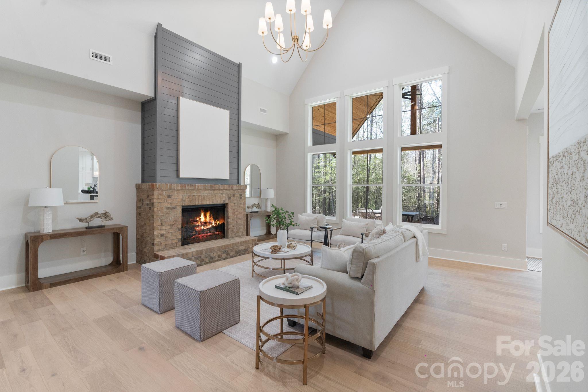 568 Longleaf Pine Lane Clover, SC 29710 - Photo 18 of 48 a living room with furniture a chandelier and a fireplace