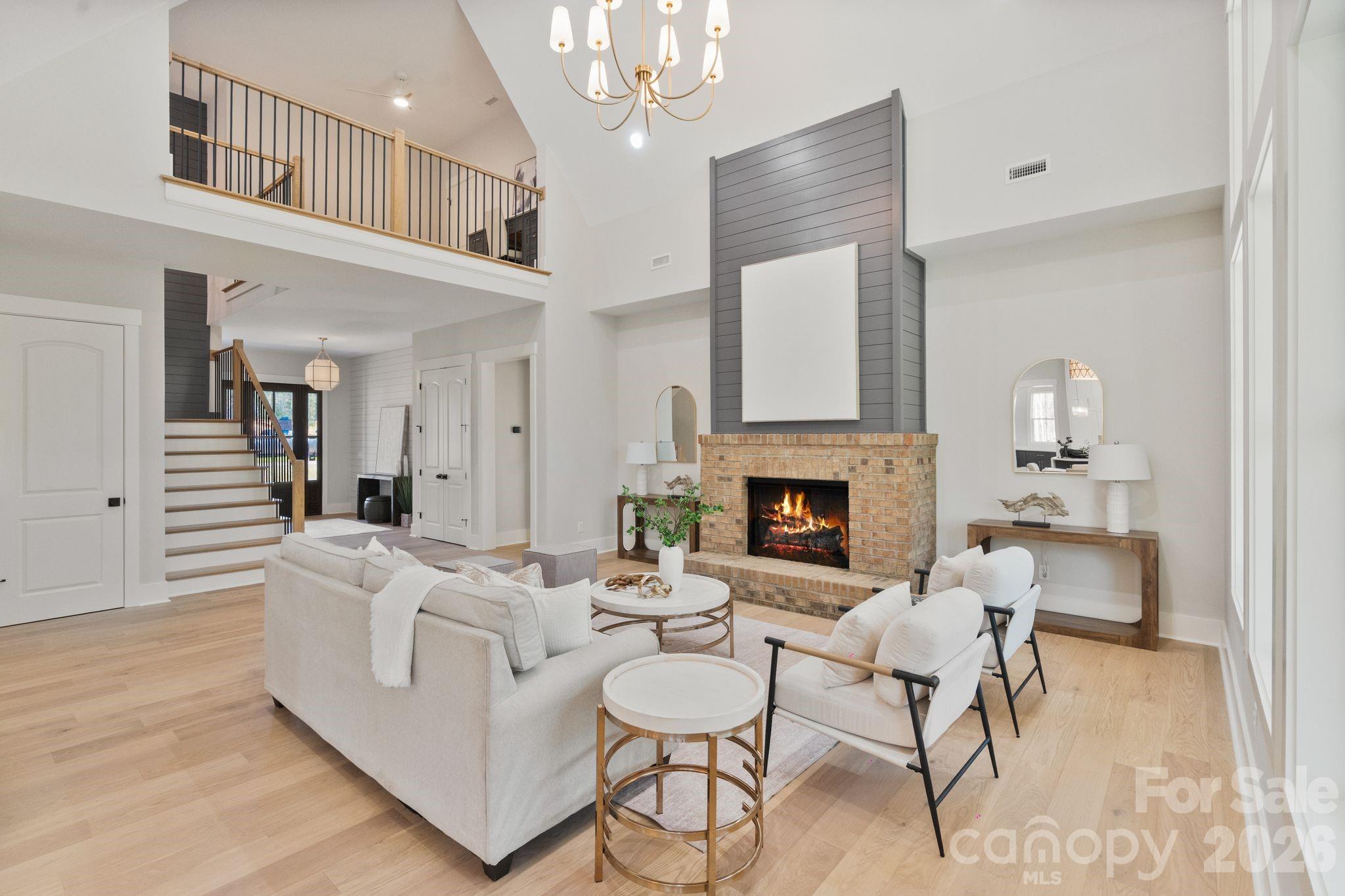 568 Longleaf Pine Lane Clover, SC 29710 - Photo 19 of 48 a living room with furniture a fireplace and a chandelier