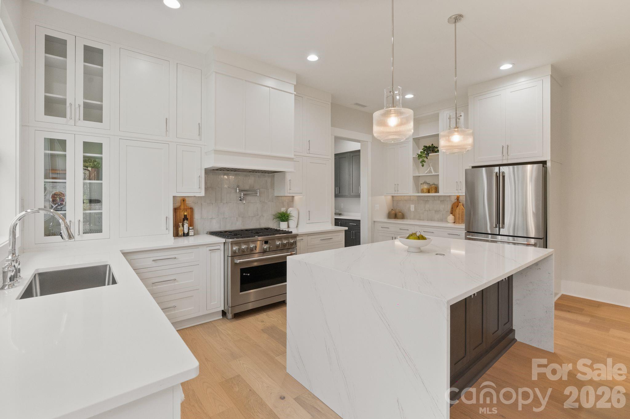568 Longleaf Pine Lane Clover, SC 29710 - Photo 6 of 48 a large kitchen with kitchen island a stove a sink a center island and a refrigerator